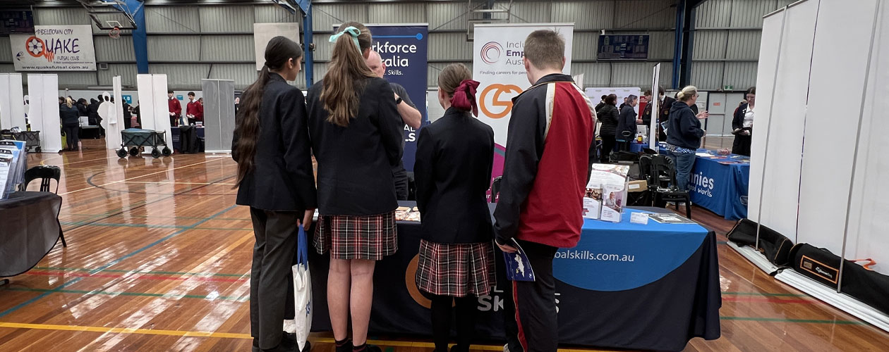 Students at the Global Skills stand at the Macarthur Careers Expo, speaking with staff about career pathways and employment support.