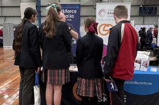 Students at the Global Skills stand at the Macarthur Careers Expo, speaking with staff about career pathways and employment support.