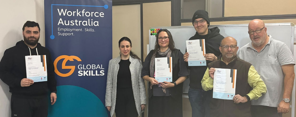 A group of graduates hold their Certificate III in Supply Chain Operations certificates at Global Skills Wetherill Park.