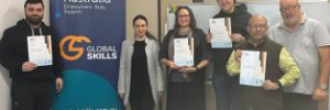A group of graduates hold their Certificate III in Supply Chain Operations certificates at Global Skills Wetherill Park.