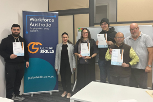 A group of graduates hold their Certificate III in Supply Chain Operations certificates at Global Skills Wetherill Park.