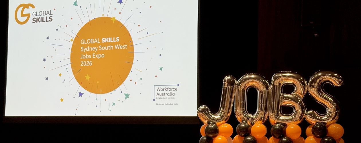 The image captures the Global Skills Sydney South West Jobs Expo 2026, featuring a presentation screen and large “JOBS” balloon decorations.